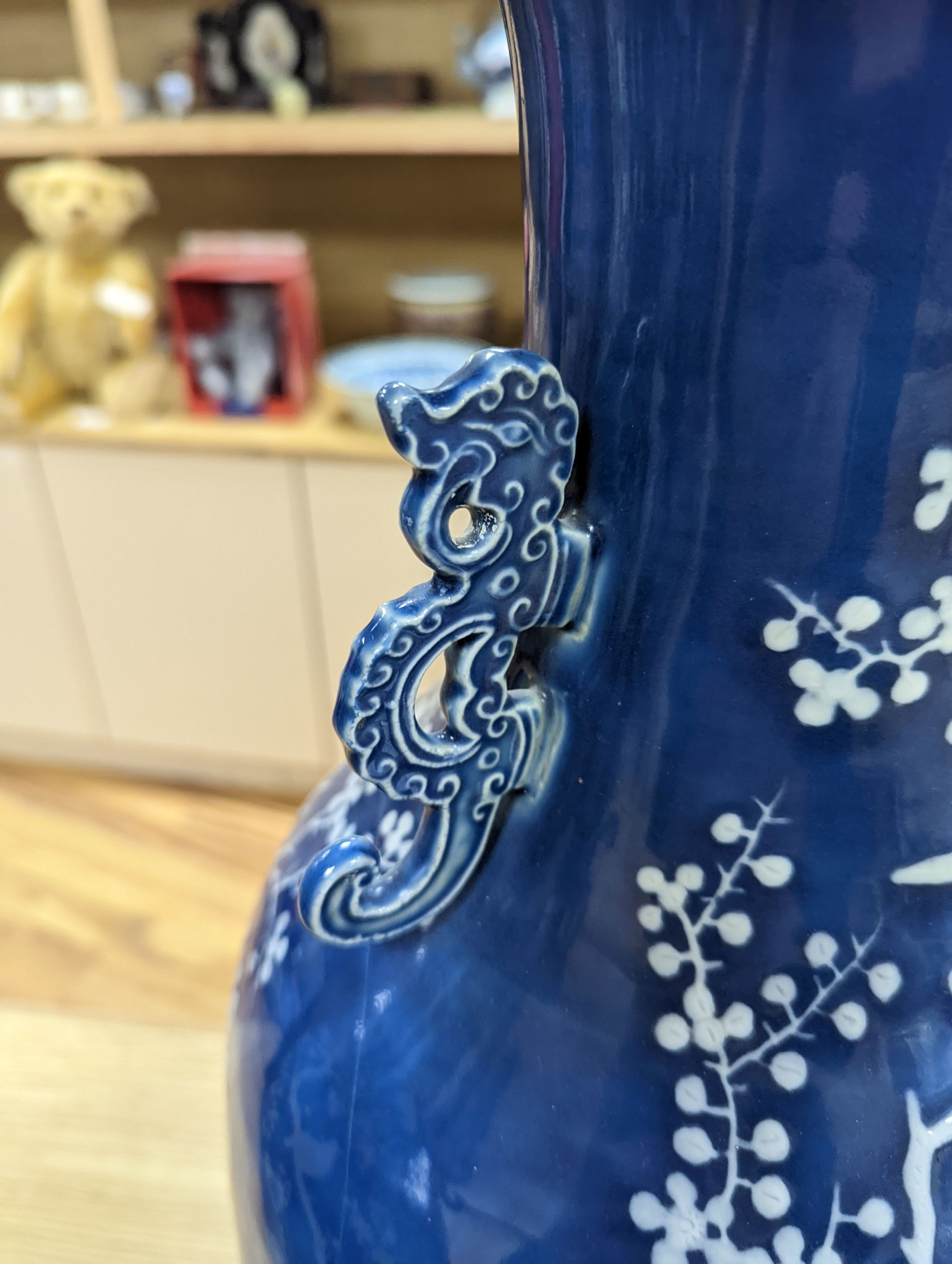 A pair of large 19th century Chinese slip decorated blue ground vases, restored, 59cm